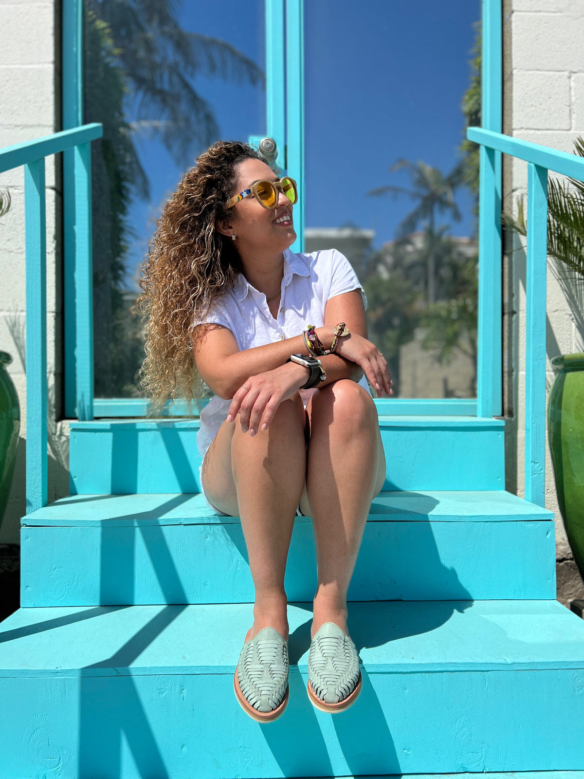 Teal woven slip-on huarache sandals on person’s feet with open toe