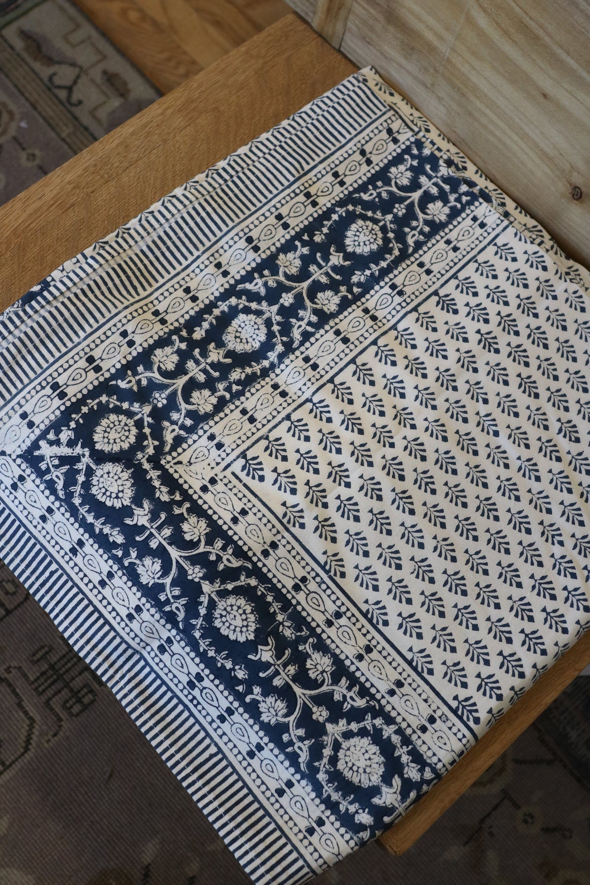 Indigo floral medallion tablecloth with striped border and ornamental motifs
