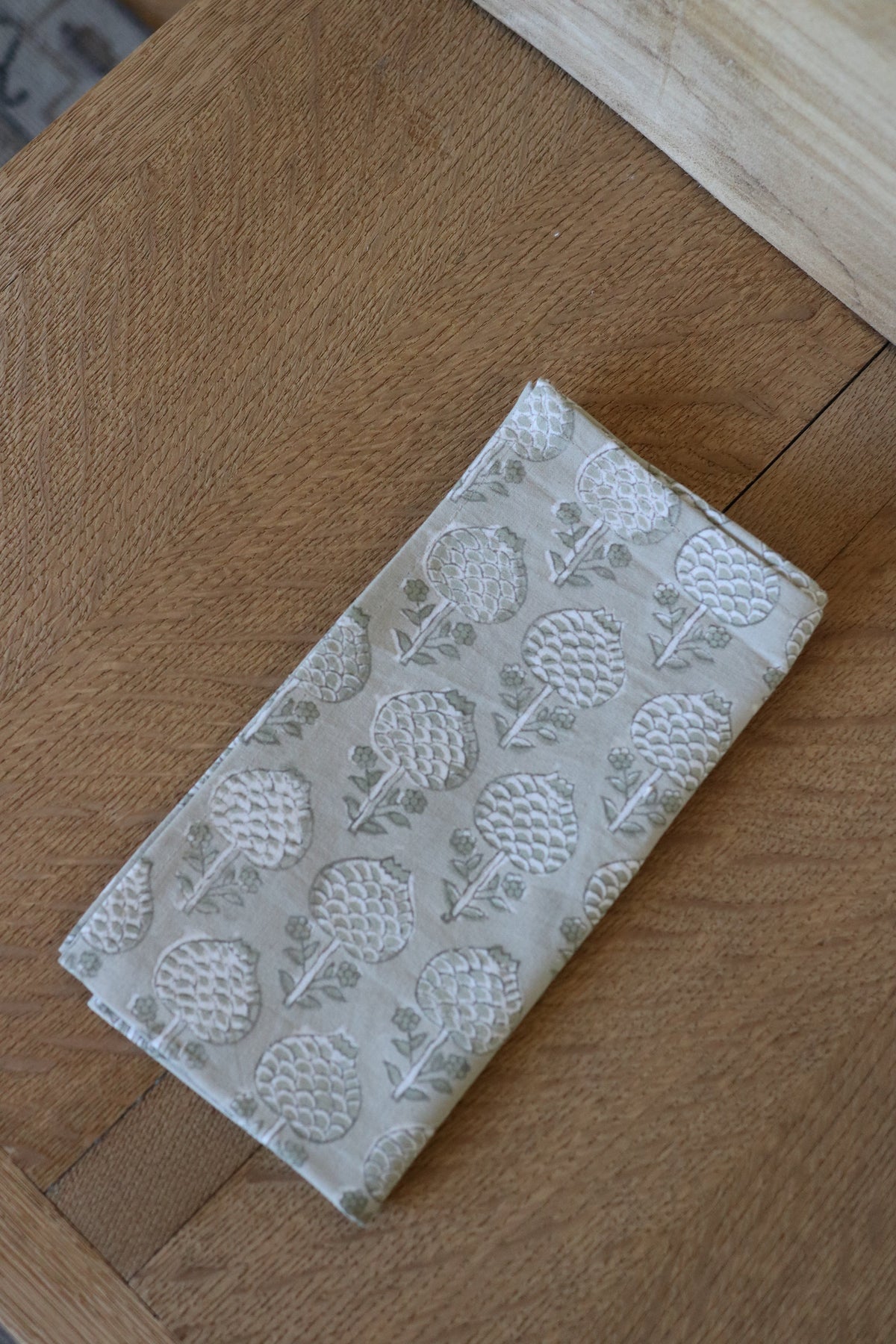 Botanical garden napkin in white with embossed leaf pattern, folded rectangle