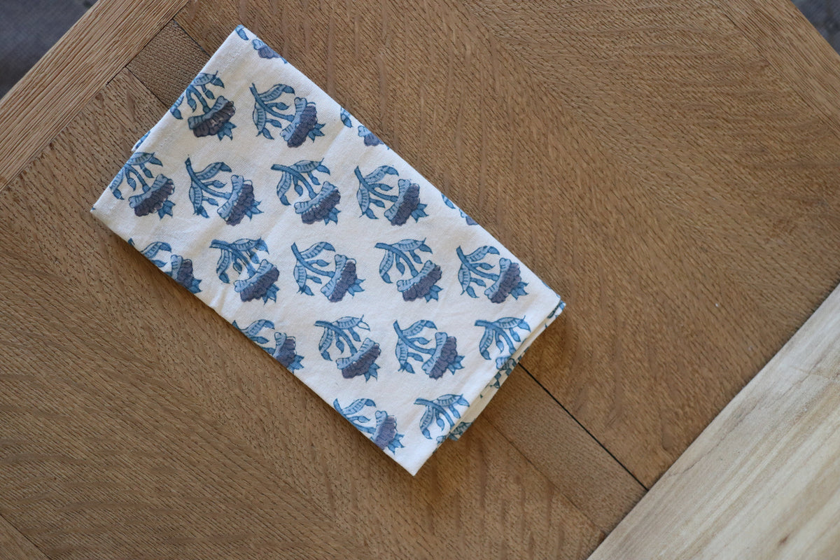 Botanical garden napkin, white with blue fish print, folded