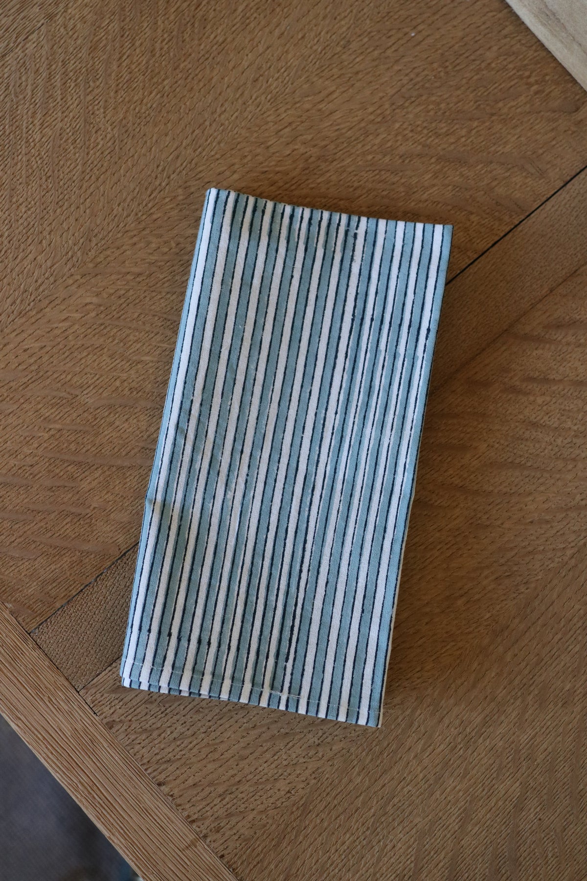 Botanical garden napkin, blue vertical stripe design, folded