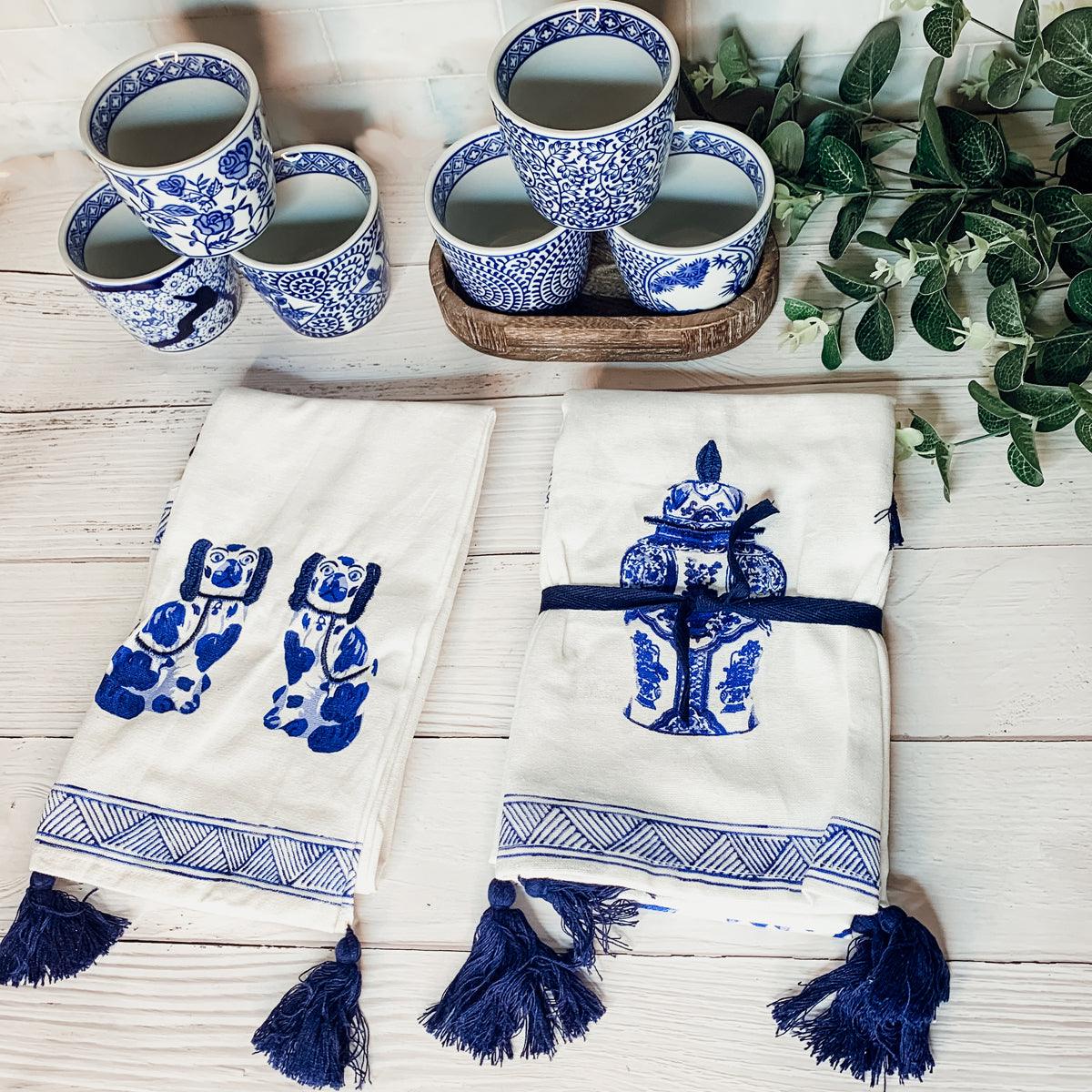Mini blue-and-white cachepots with potted leaves and folded blue patterned towels
