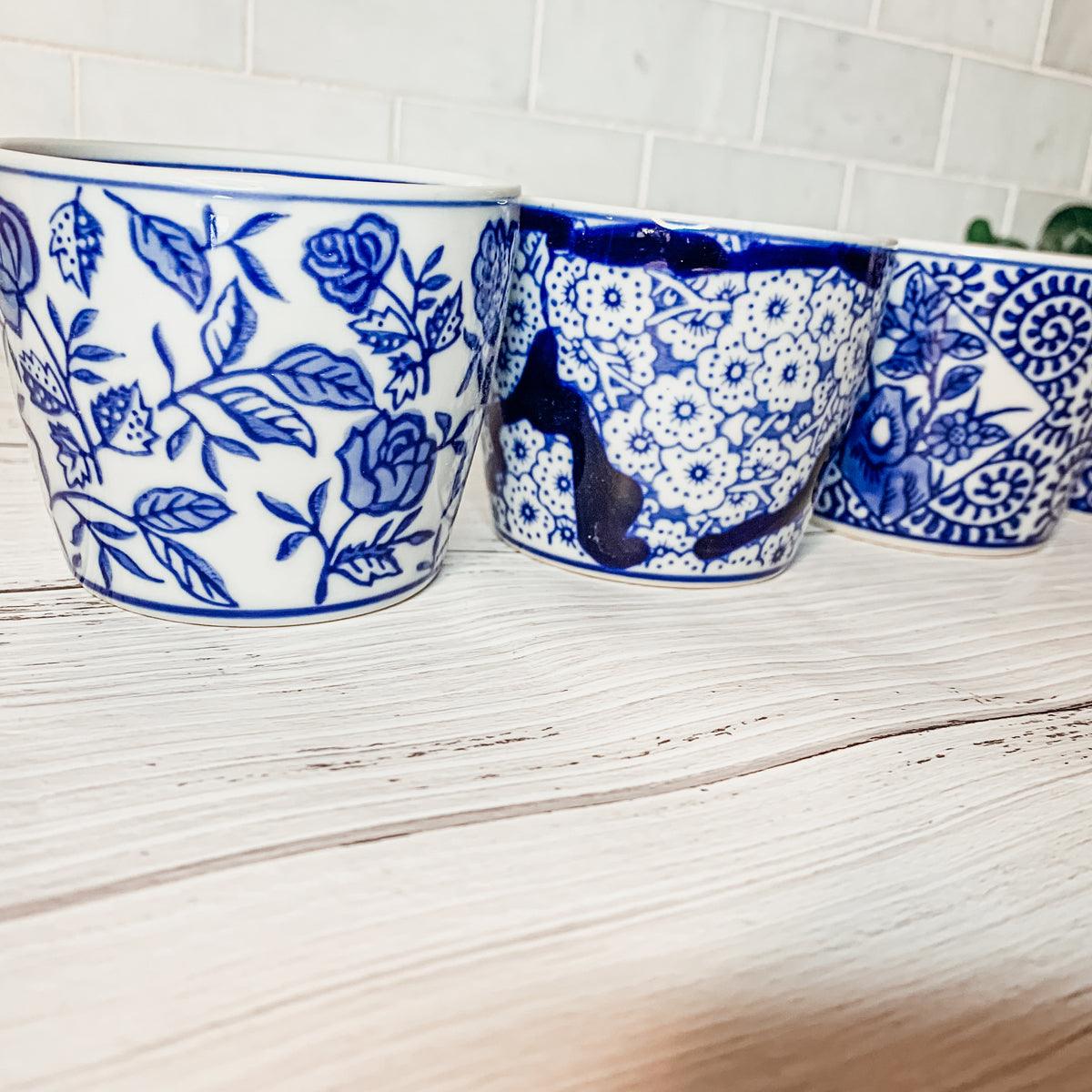 Mini chinoiserie cachepots close-up of three blue-and-white patterned mini ceramic pots