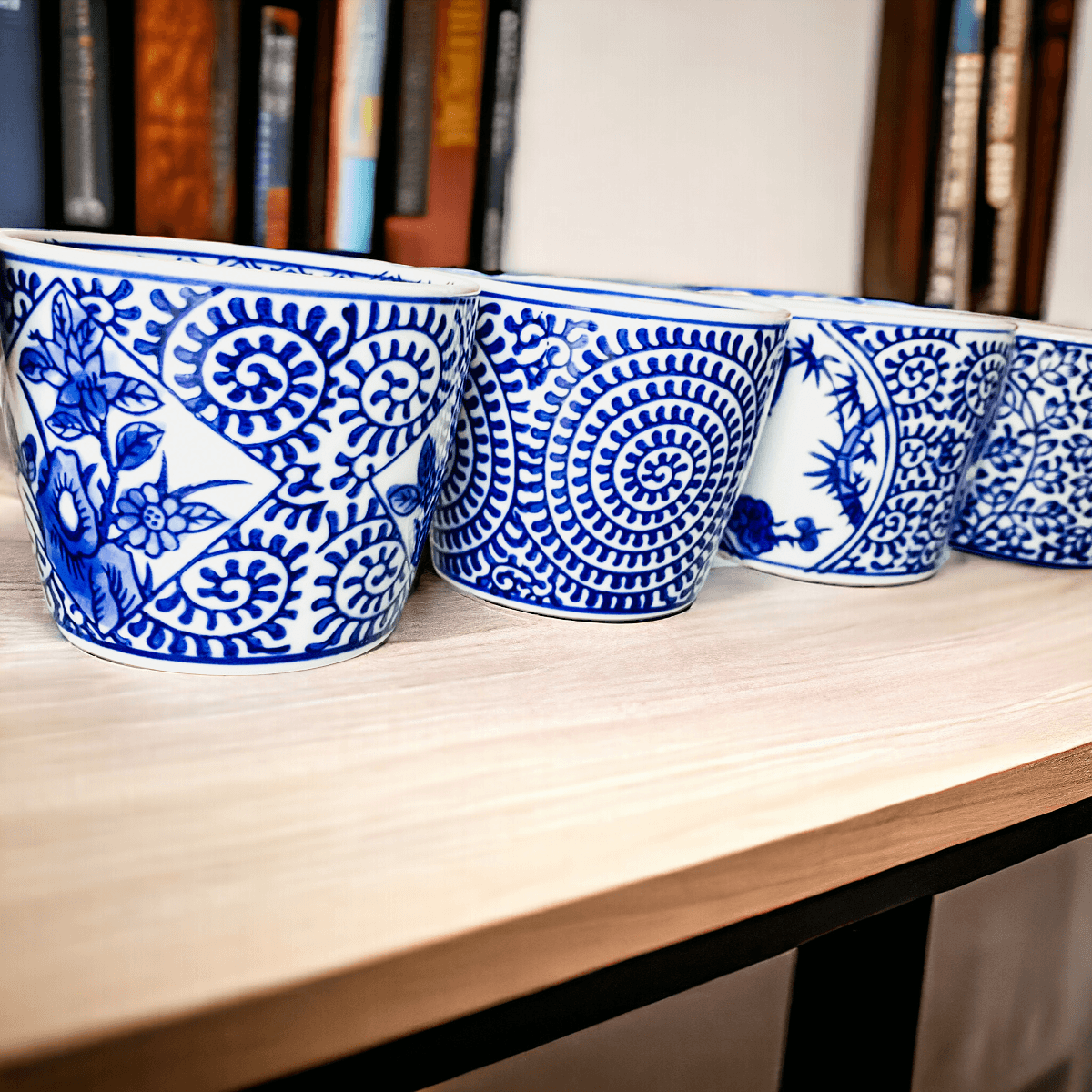 Mini chinoiserie cachepots row of blue-and-white patterned mini ceramic planters on shelf