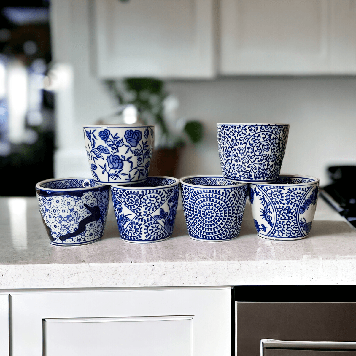 Mini chinoiserie cachepots set of small blue-and-white patterned ceramic planters on counter