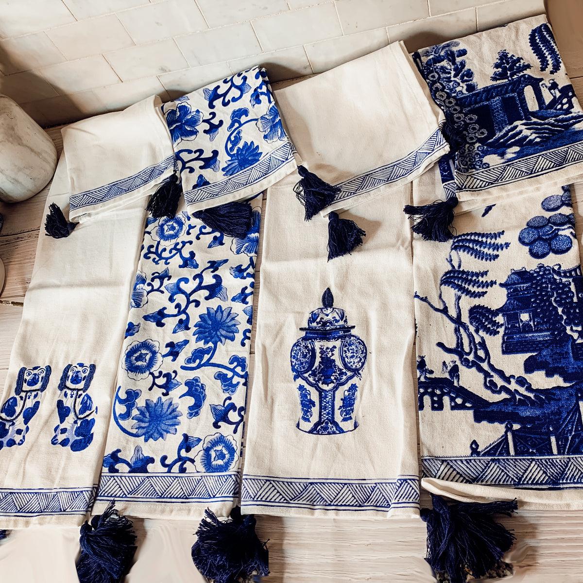 Chinoiserie tea towels with blue-and-white motifs and fringed tassels on white