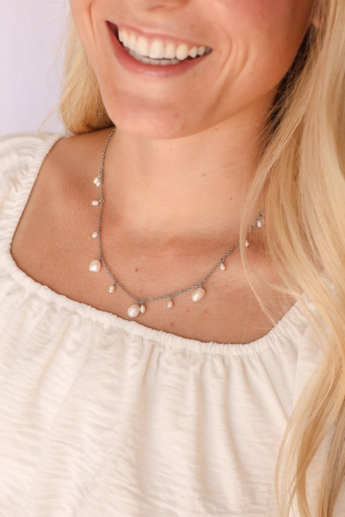 Silver Calypso Necklace with pearl drops worn around the neckline