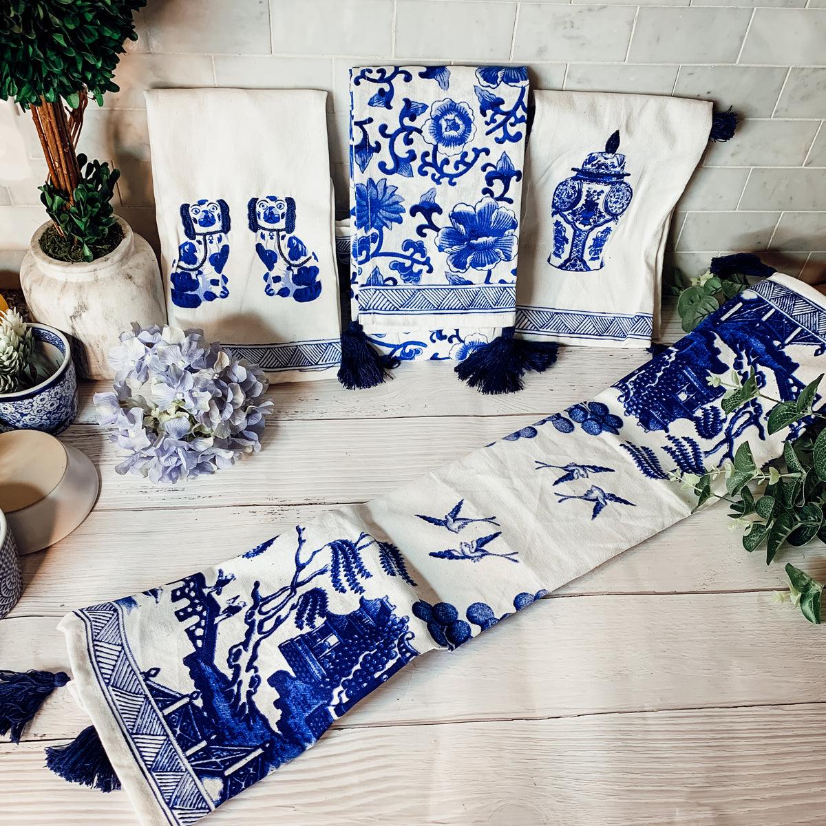 Cream and blue chinoiserie tea towels with landscape prints, navy tassel trim