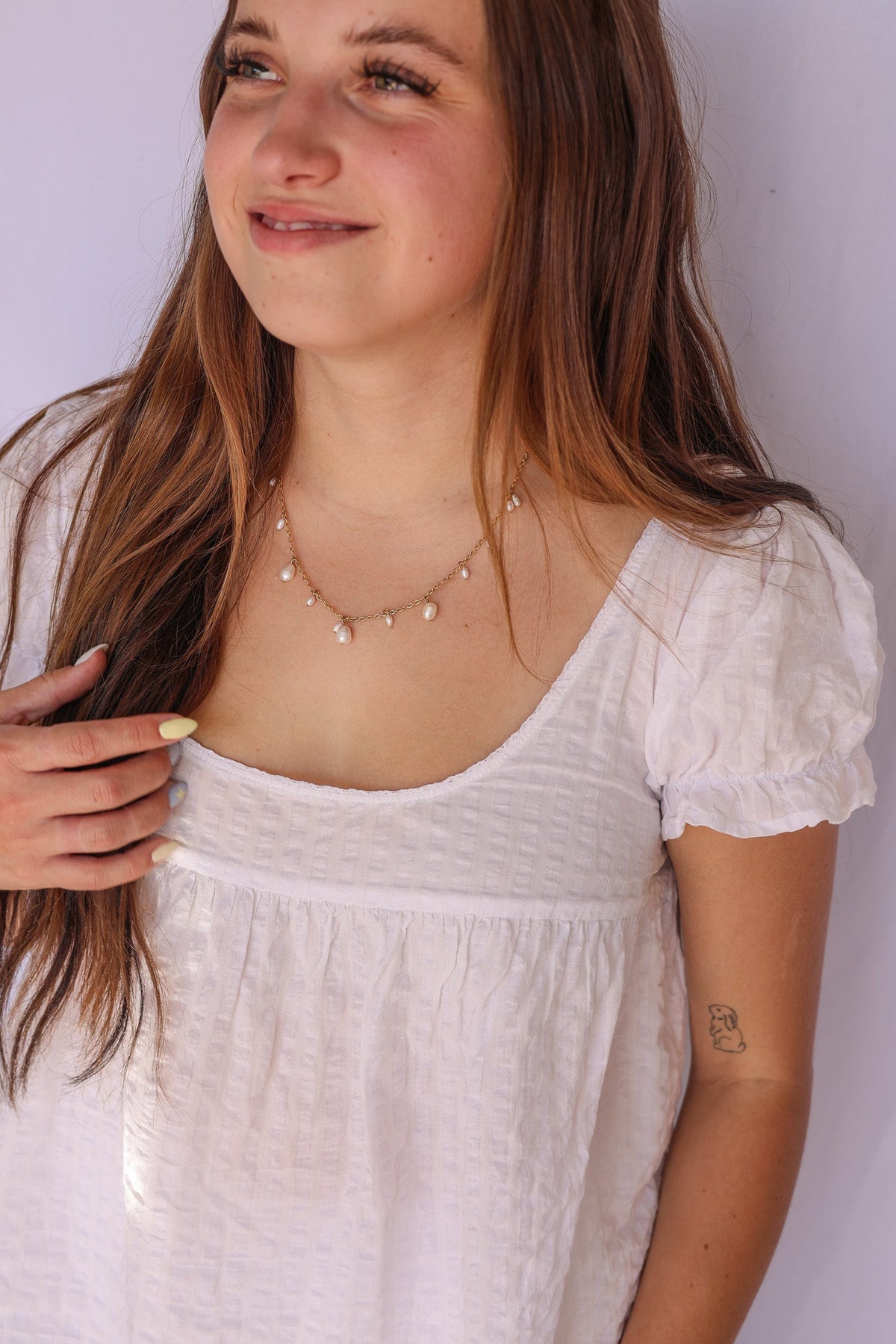 Calypso Necklace with small pearl drops worn at the neckline