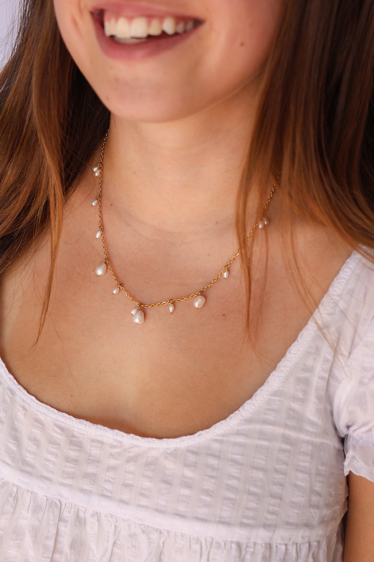 Gold Calypso Necklace with pearl drops worn at the neckline