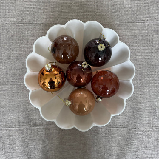 Mixed brown and amber glass Christmas ornaments with metal caps and hanging loops
