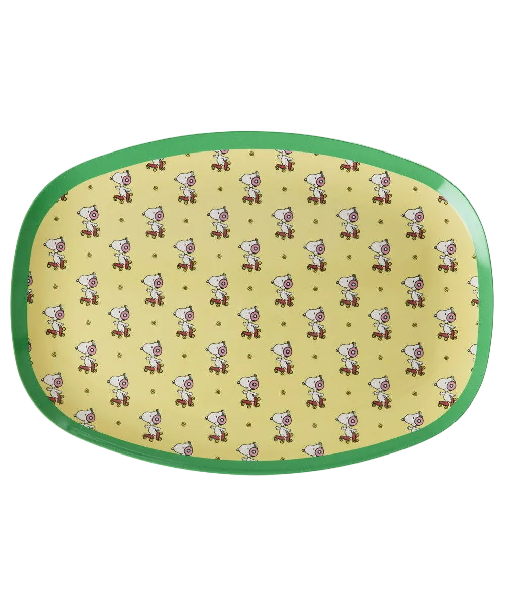 Yellow oval serving plate with green rim and repeating Snoopy pattern