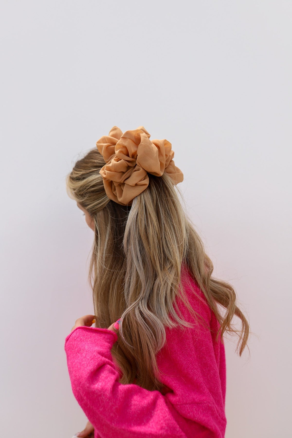 Brown jumbo scrunchie on hair with gathered fabric rosette