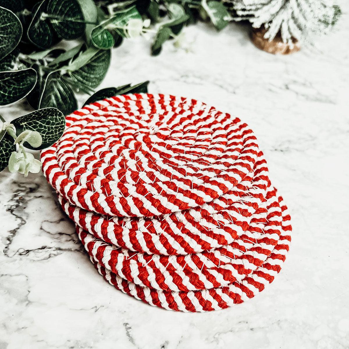 Round woven coaster with red-and-white striped candy cane pattern