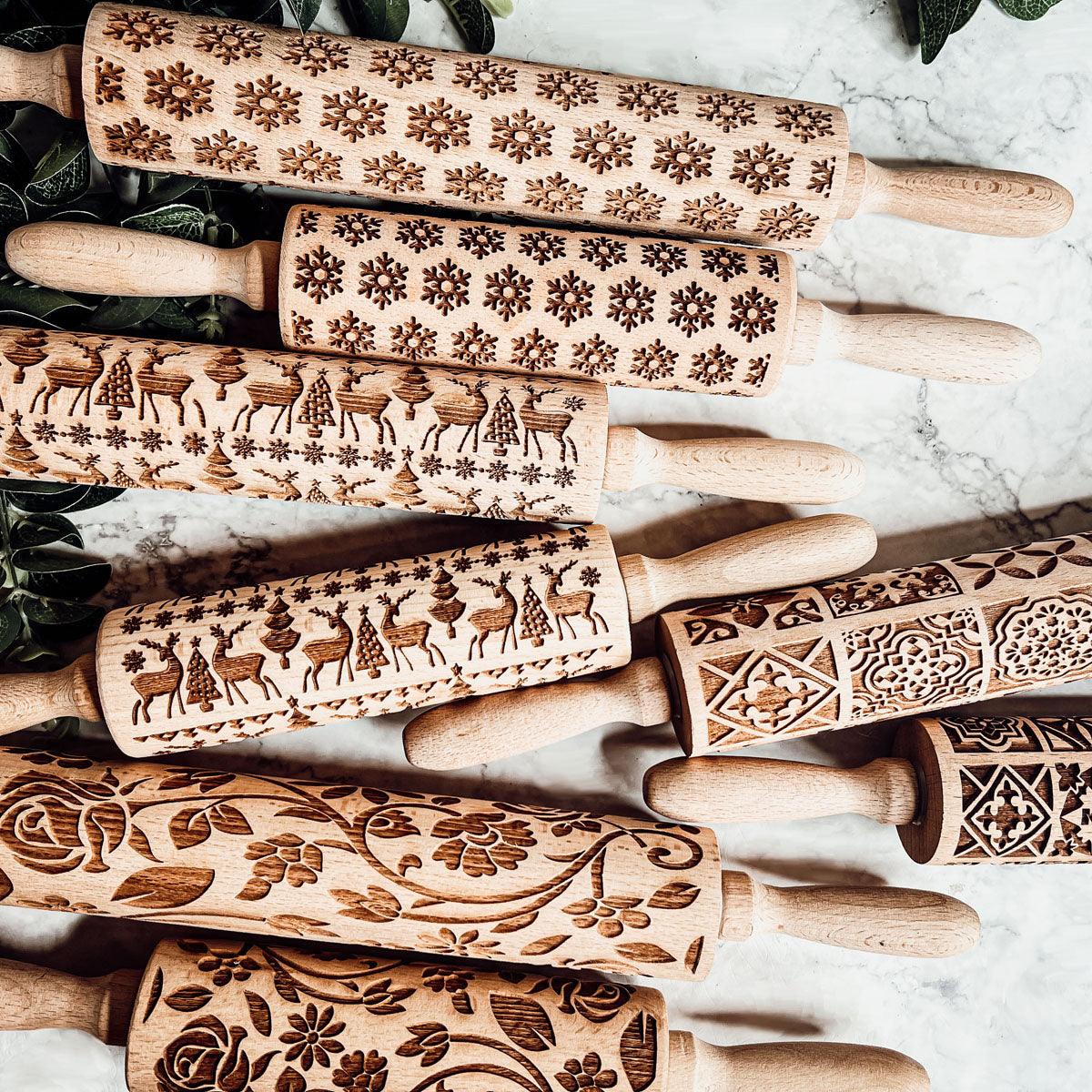 Set of wooden rolling pins featuring winter and animal etched designs in brown