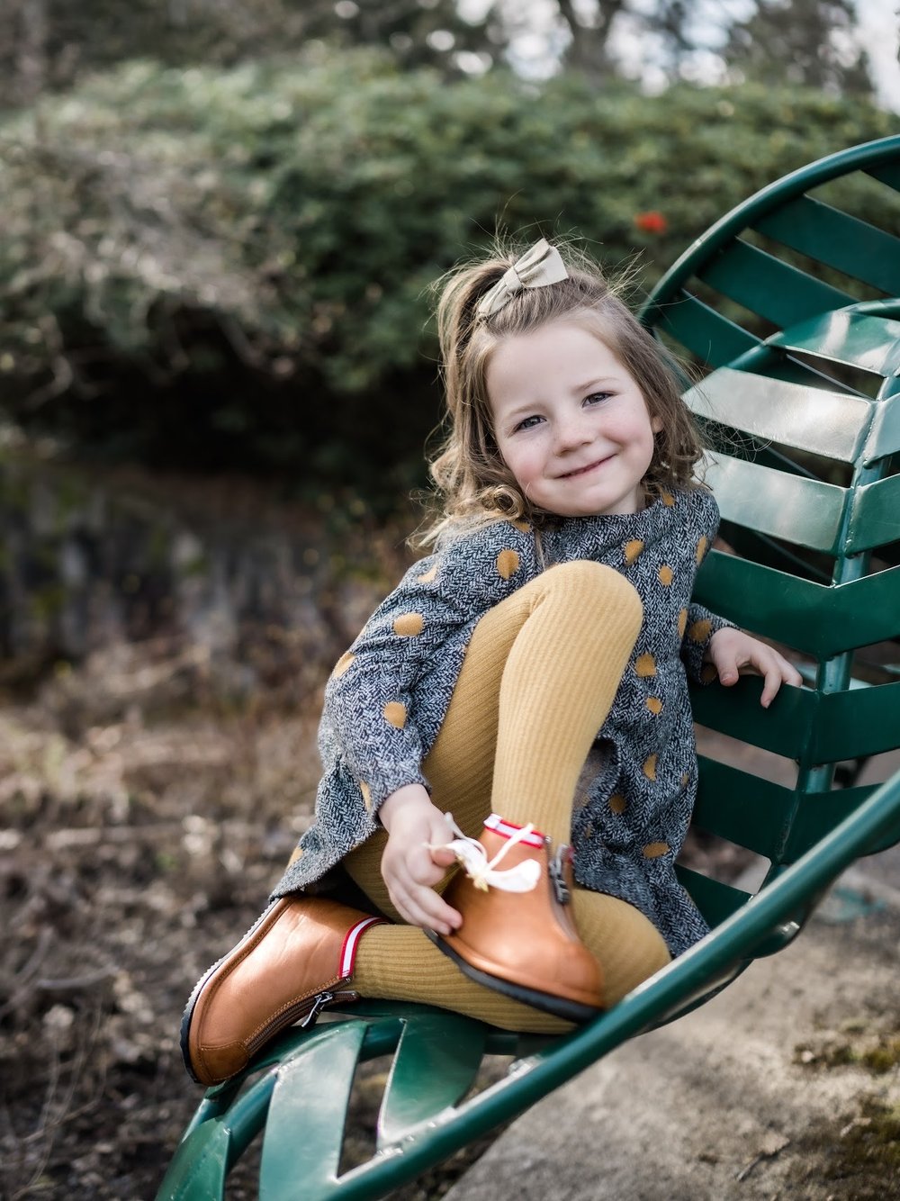 Toddler ankle boots on child, brown leather look with red-trimmed collar and zipper
