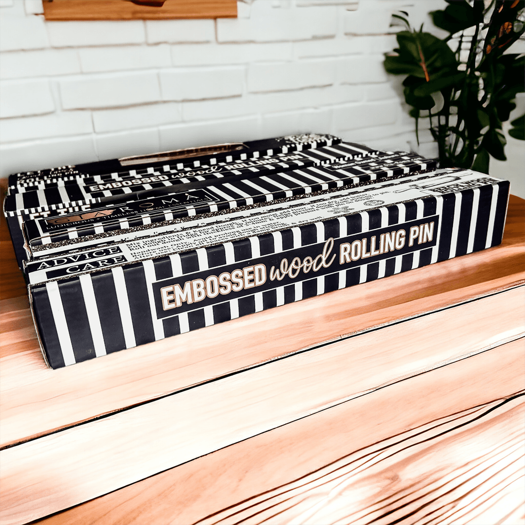 Striped gift box showing embossed wood rolling pin branding and decorative text