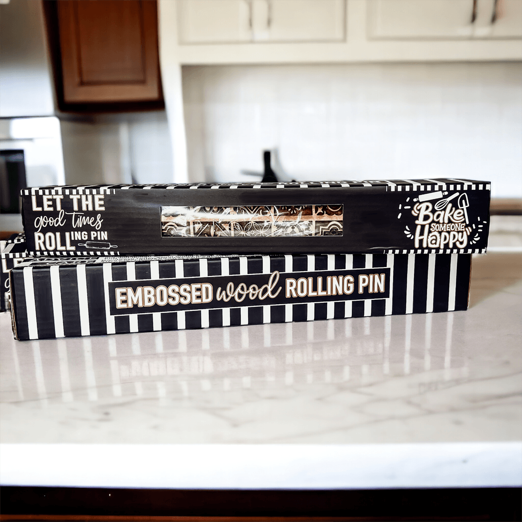 Striped rolling pin gift box on tabletop with embossed “EMBOSSED wood rolling pin” text