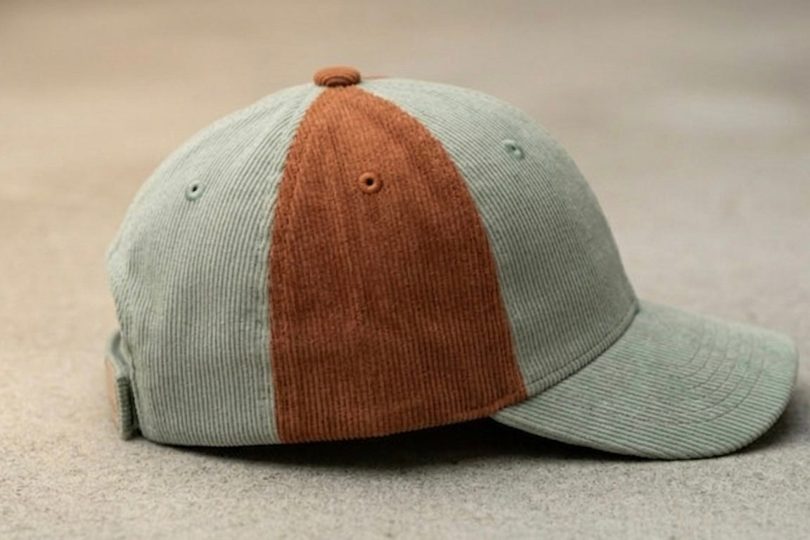 Retro baseball cap in sage green with rust-brown front panel and curved brim