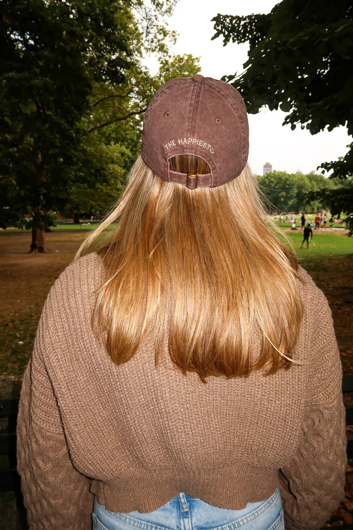 Brown baseball cap with rear logo detail and curved brim