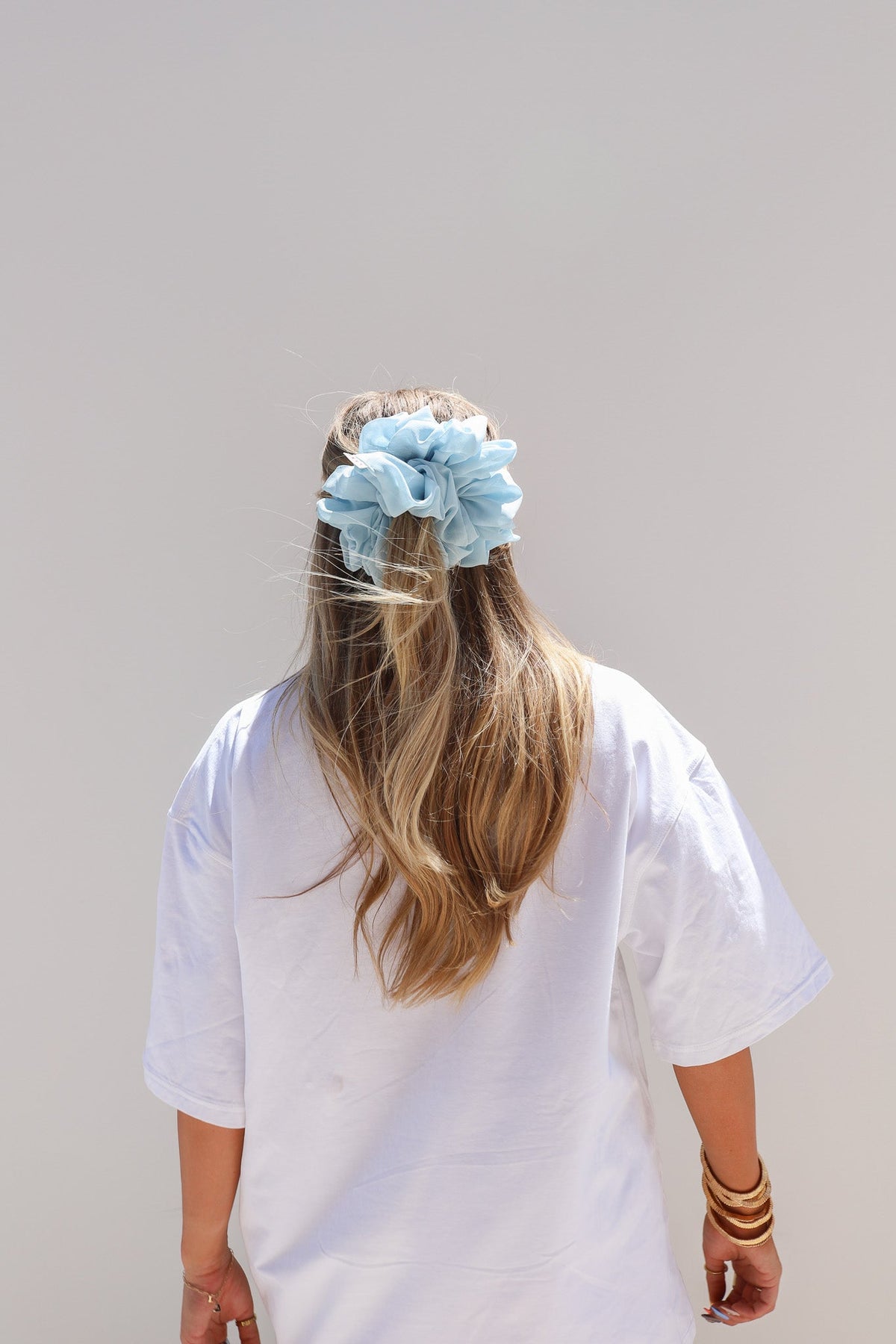 Jumbo scrunchie with light blue ruffled fabric flower detail