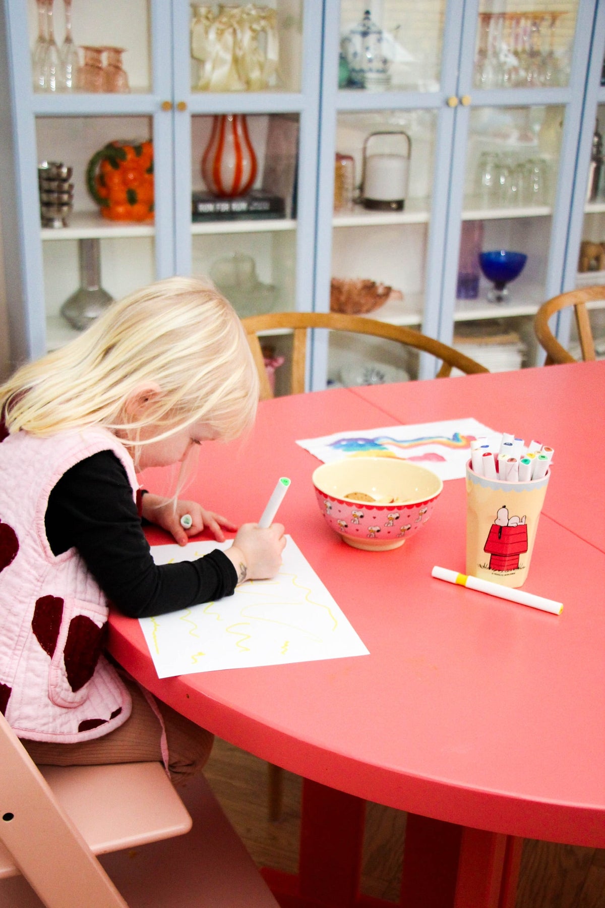Pink character-print bowl at children’s craft table