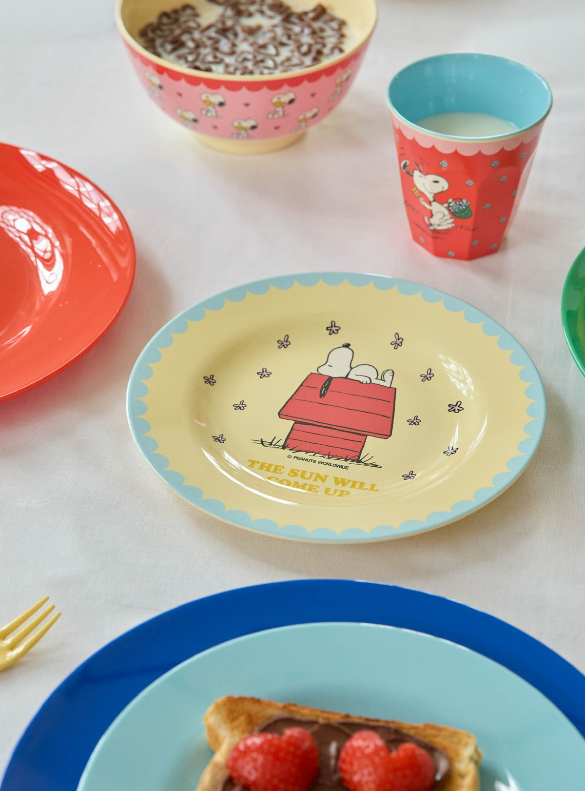 Pink character-print bowl with pale base, filled with dark food