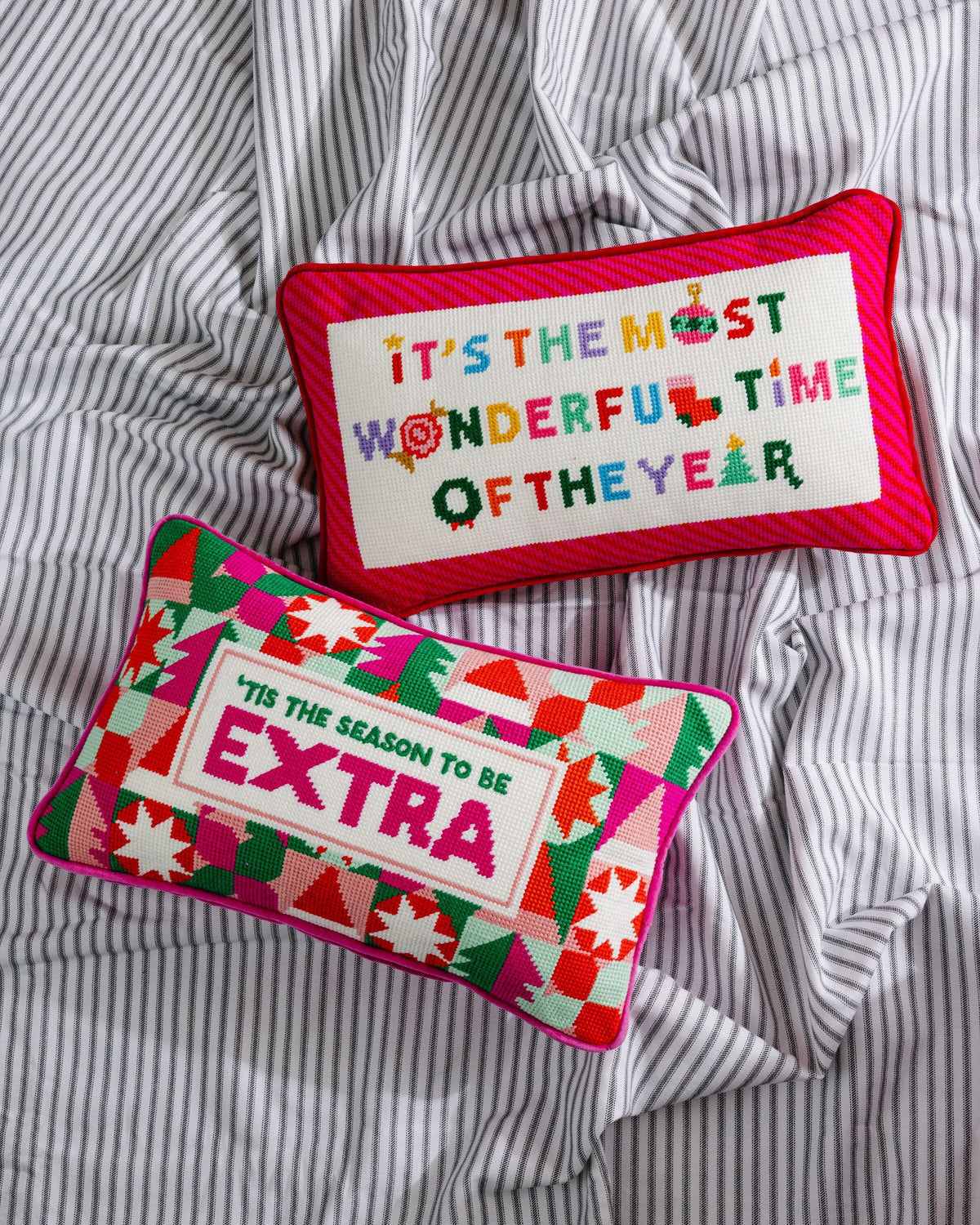 Red-trim needlepoint pillow with "It's the most wonderful time of the year" text.