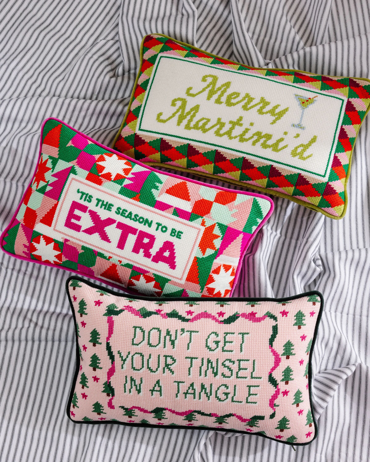 Needlepoint Christmas pillows: 'Merry Martini' and 'DON'T GET YOUR TINSELS IN A TANGLE'.