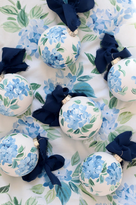 Hand-painted hydrangea ornaments with navy ribbons and blue flowers