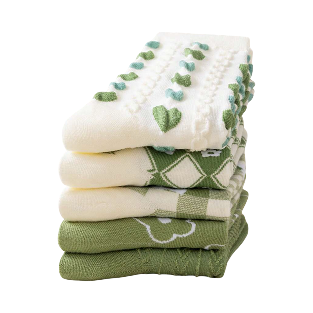 Stack of green-and-white crew socks with clover hearts and plaid patterns