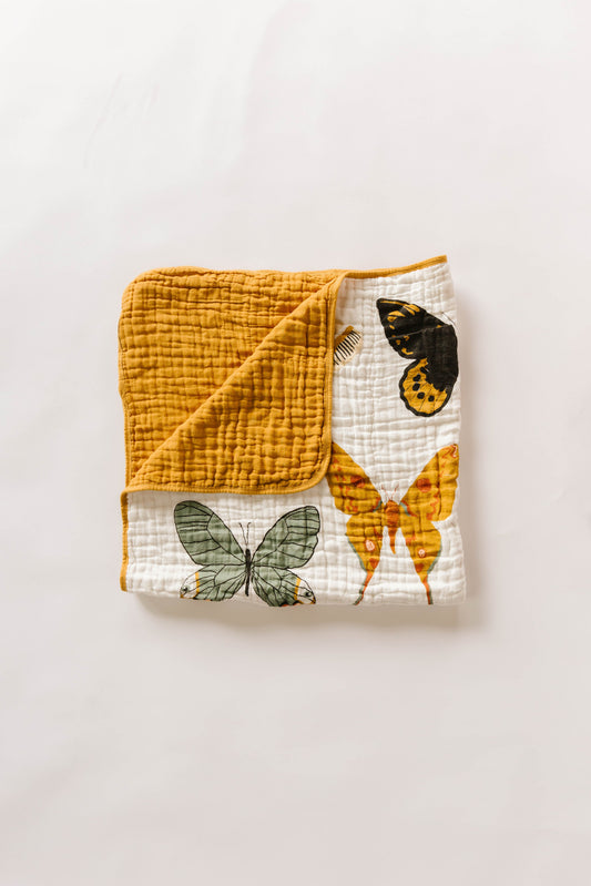 Mustard and white quilt with butterfly print corner, soft quilted texture