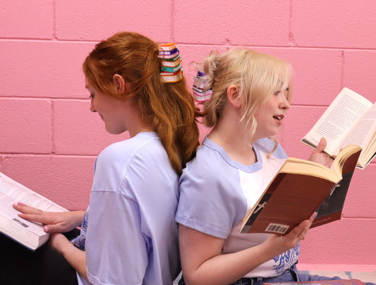 Book stack hair claw holding light blonde hair with stacked colorful mini books