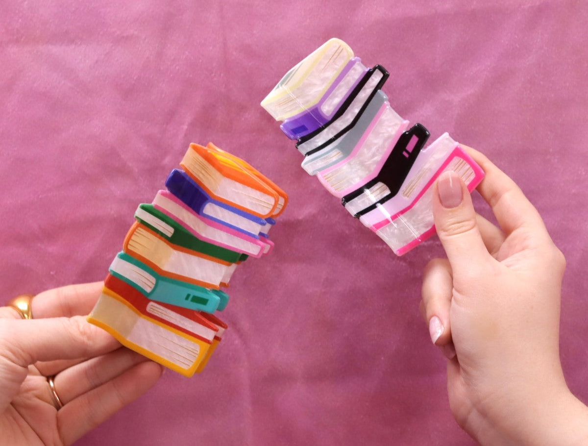 Book stack hair claws: two stacked mini-book clips in bright rainbow colors