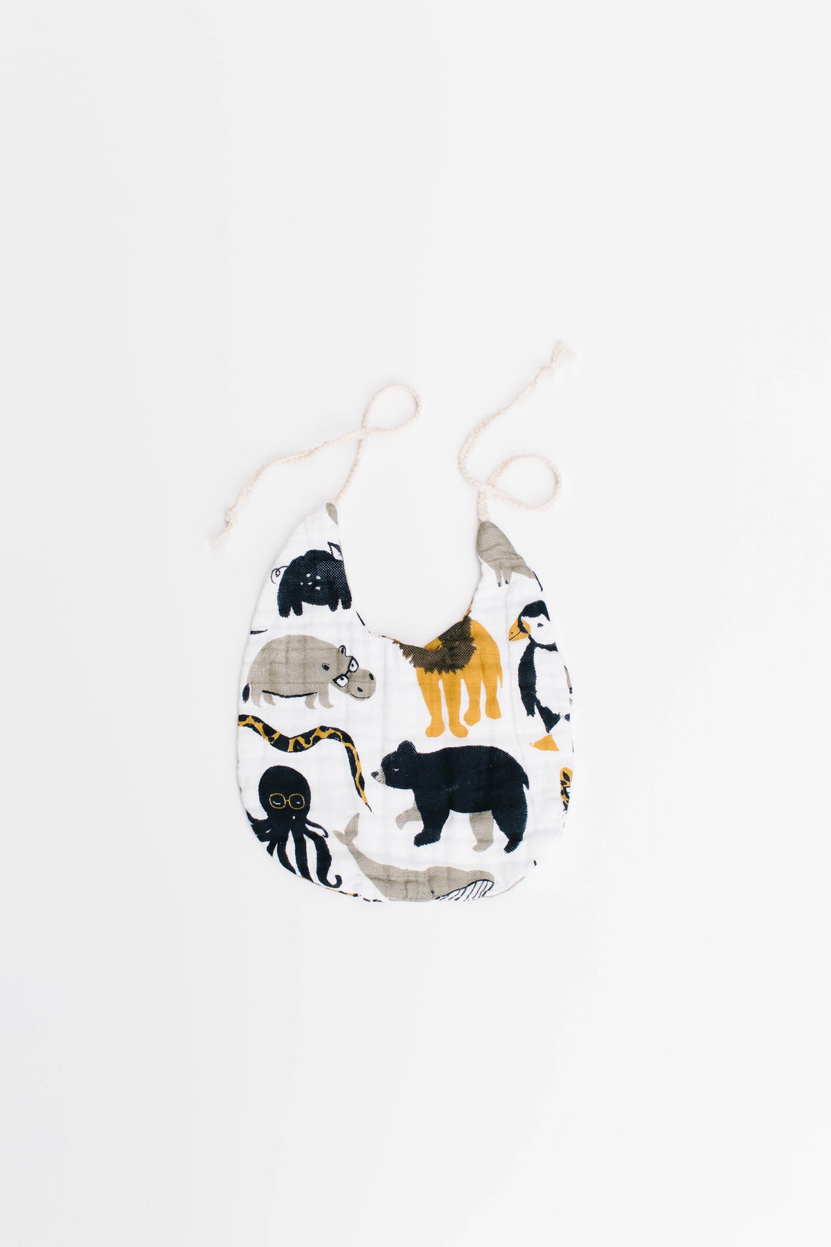 Animal print baby bib pouch-style with dangling ties and mixed zoo icons