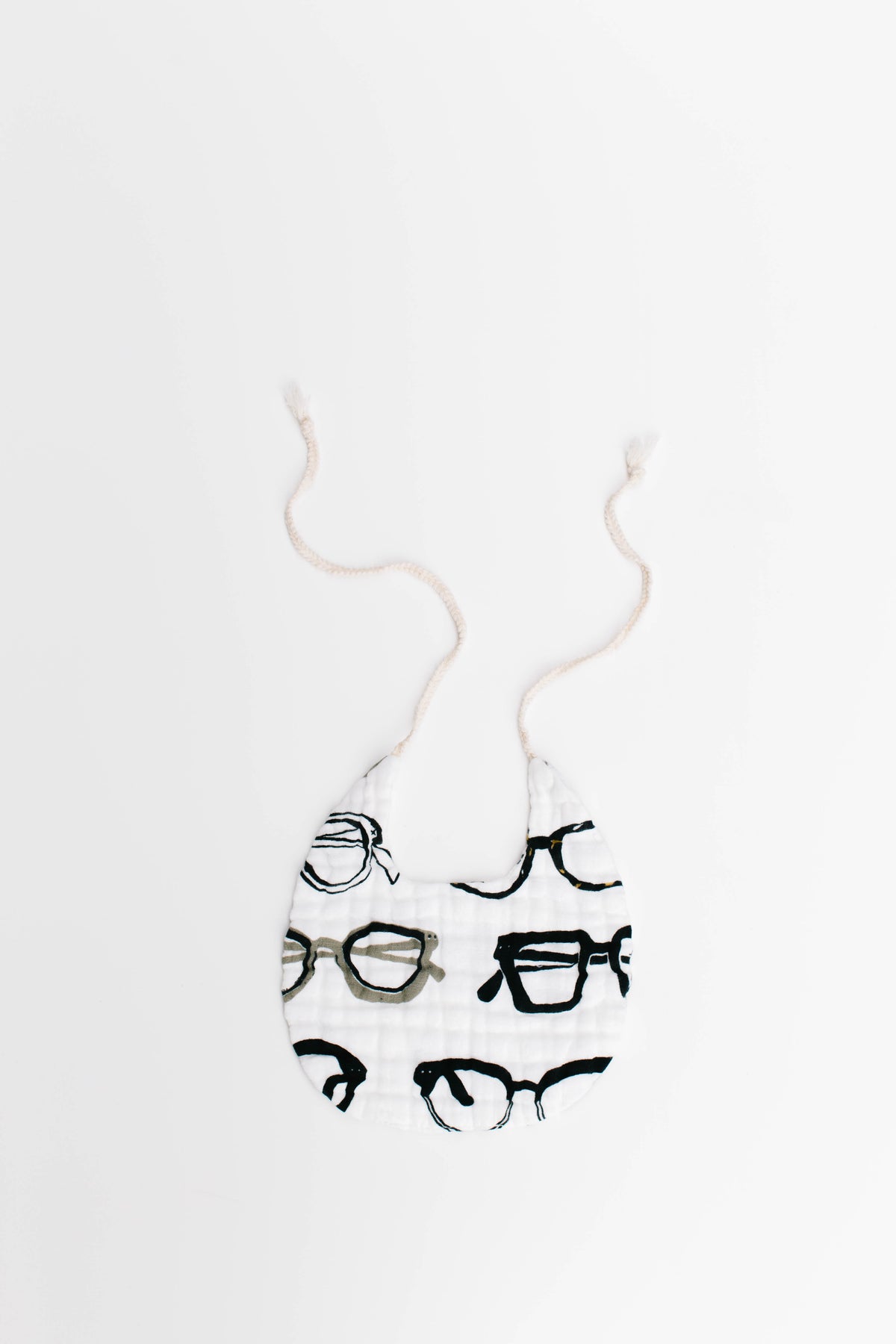 Animal print baby bib with black glasses and small animal motifs