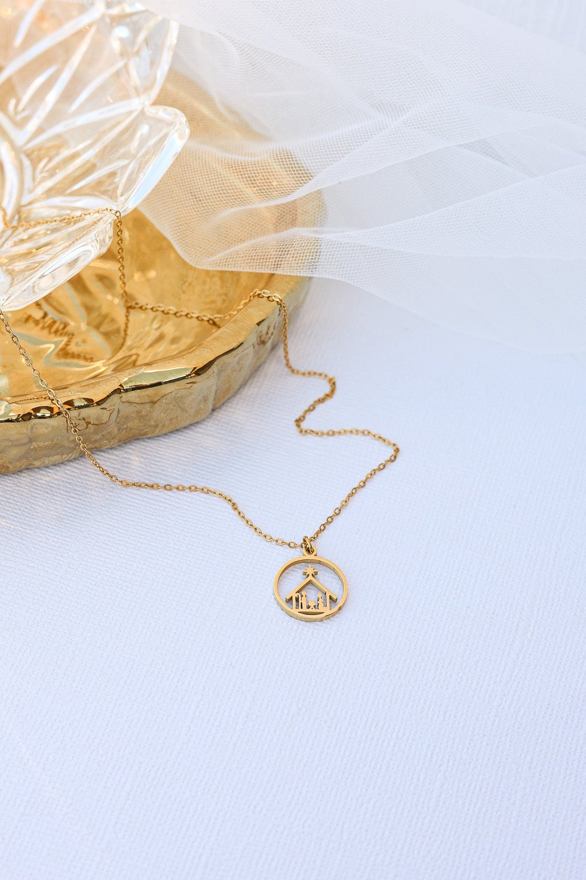 Gold Nativity necklace with circular pendant and fine chain