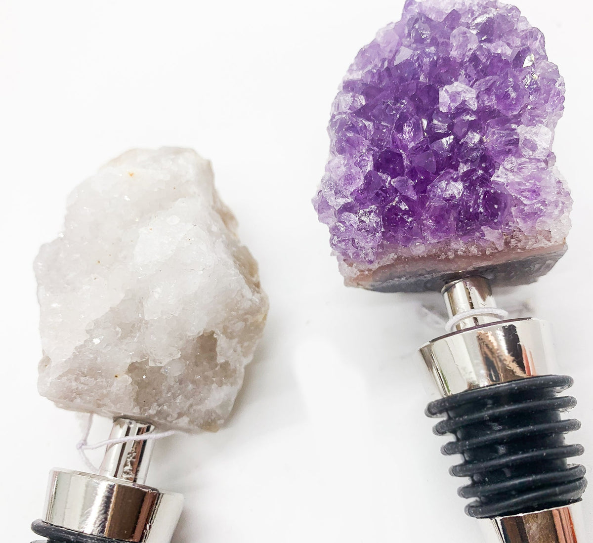 Pair of crystal wine bottle stoppers with purple amethyst and white stone crystal tops