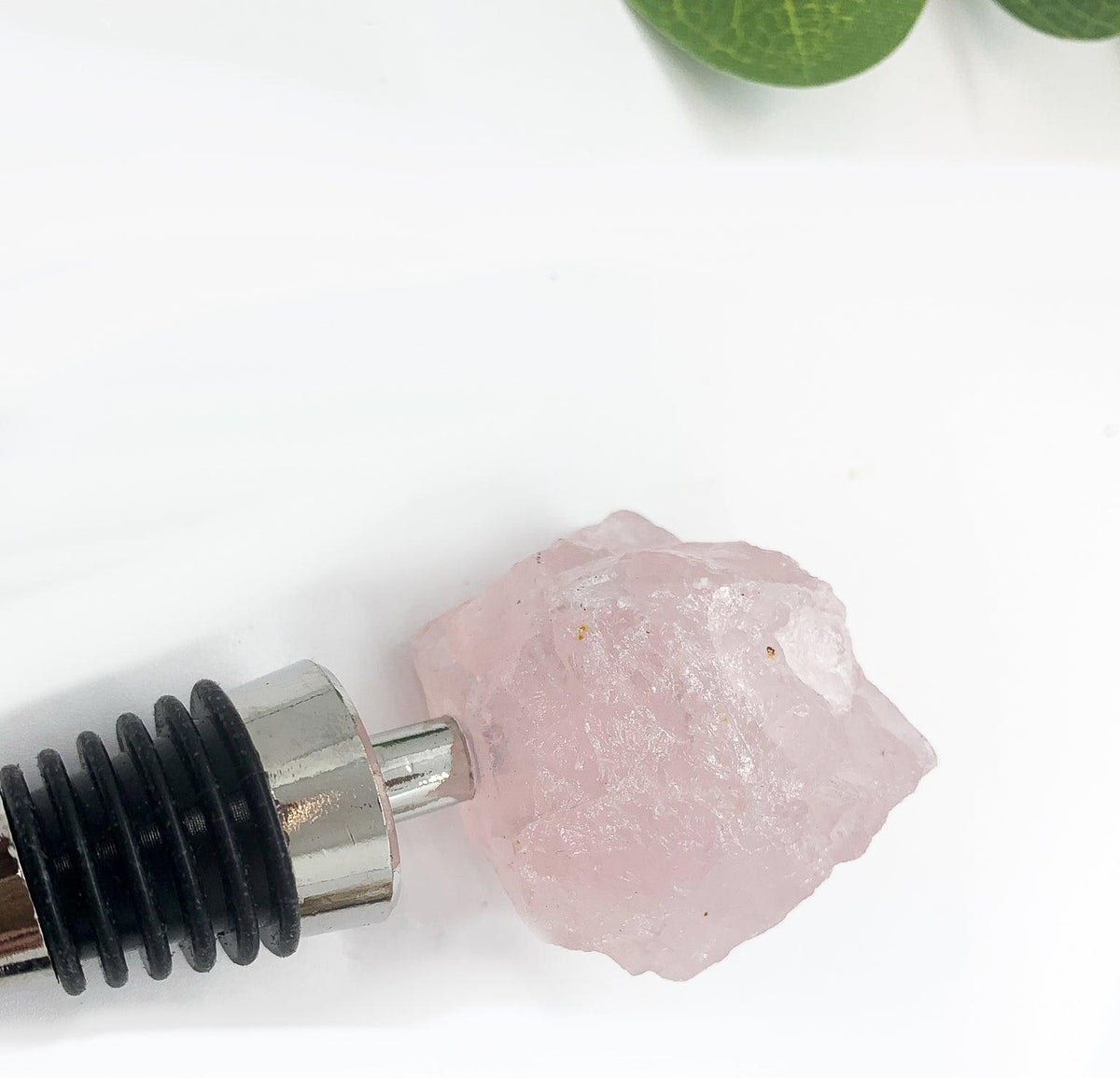 Naturally Bougie pink crystal bottle stopper with silver cone tip and black ribbed ring