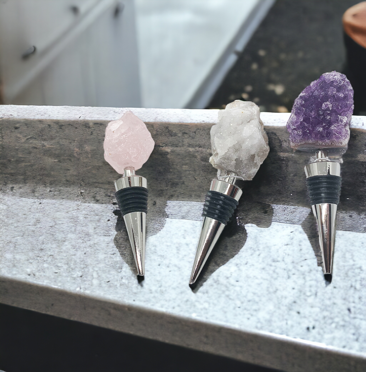 Crystal wine bottle stopper trio with pink rose quartz, white quartz, and purple amethyst tops