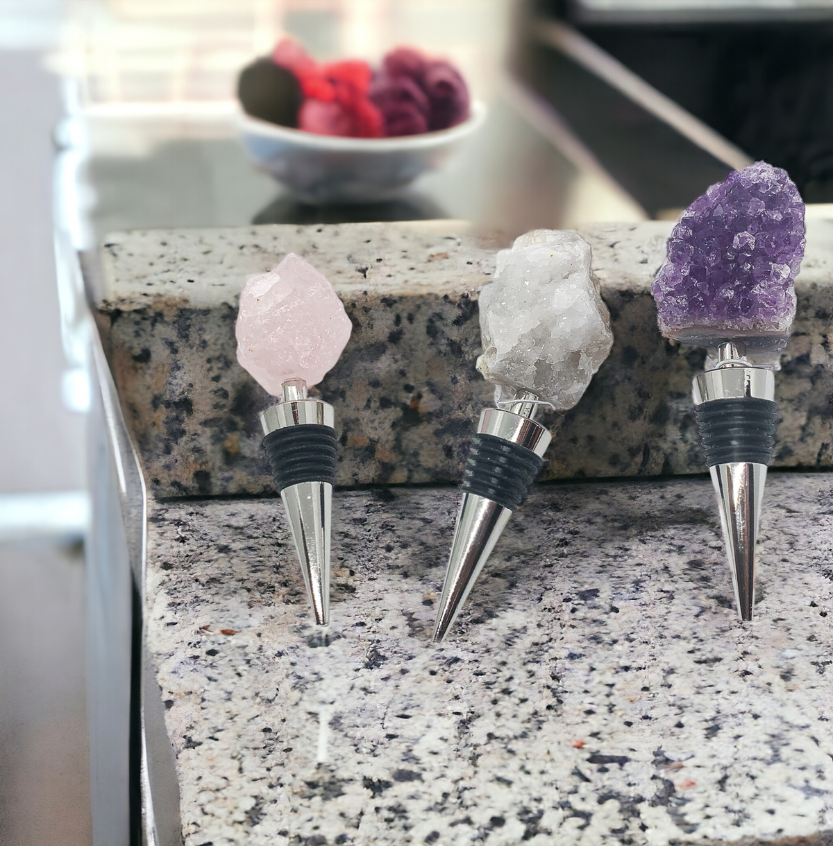 Crystal wine bottle stopper set with pink, clear, and purple crystal tops and metal spouts