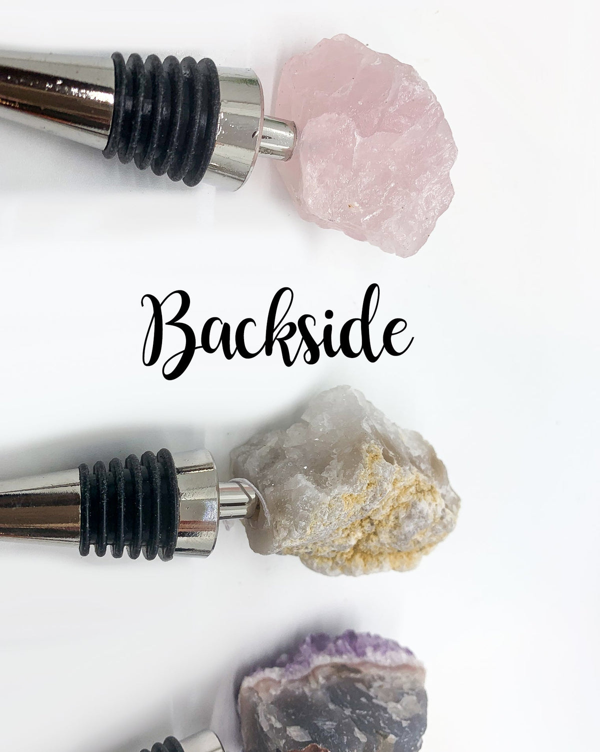 Rose quartz and white crystal wine bottle stopper back views with black ribbed collars