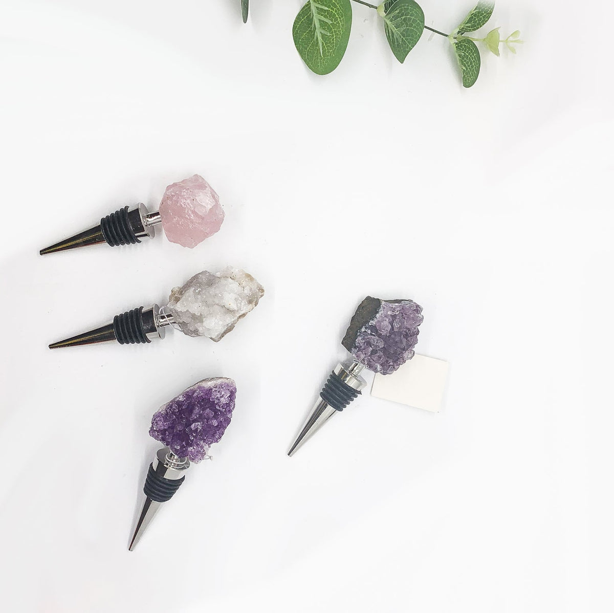 Naturally Bougie assorted crystal bottle stoppers with black ribbed holders and metal cones