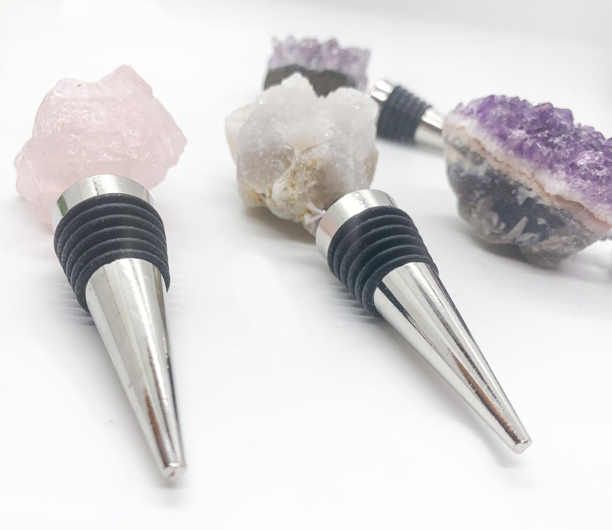 Naturally Bougie gemstone bottle stopper set with purple, white, and amethyst-like crystals