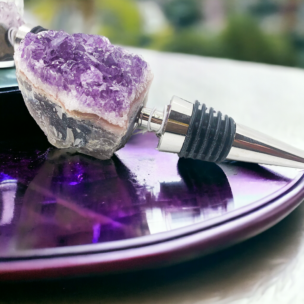 Purple amethyst wine bottle stopper with chrome metal spout and black ribbed collar