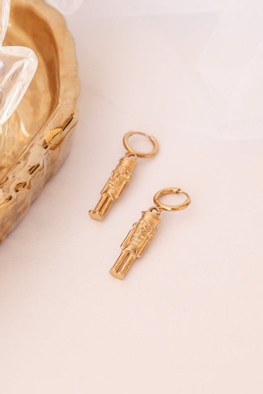 Gold nutcracker huggie hoop earrings with dangling soldier charms