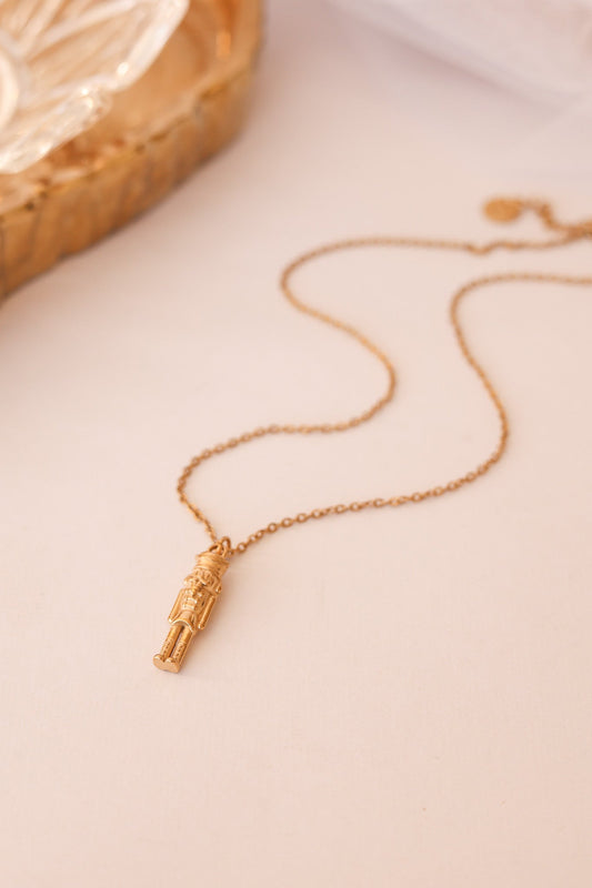 Gold nutcracker necklace with a miniature soldier pendant and fine chain