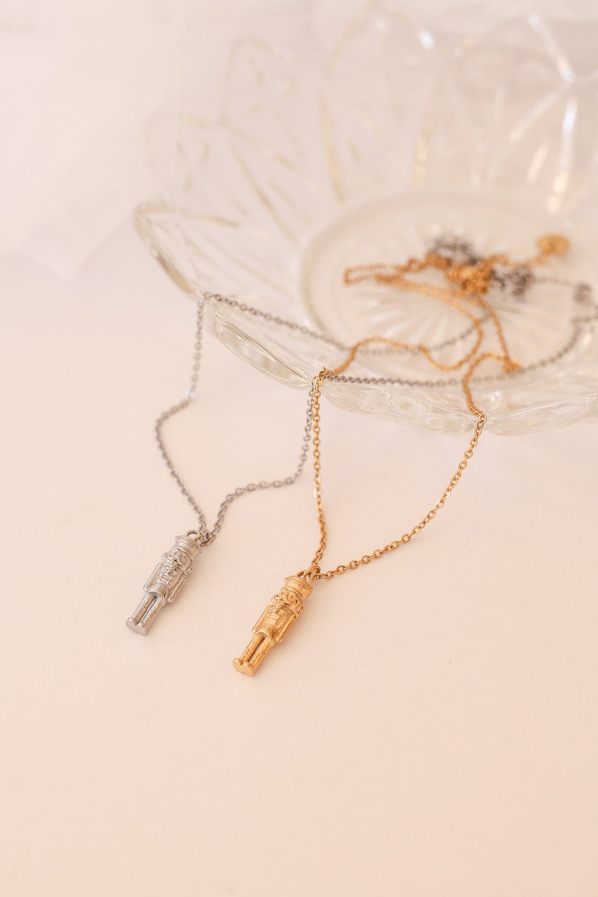 Gold and silver nutcracker necklaces with miniature soldier pendants