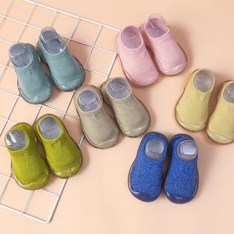 Baby sock shoes with clear soles in multiple colors, shown as pairs