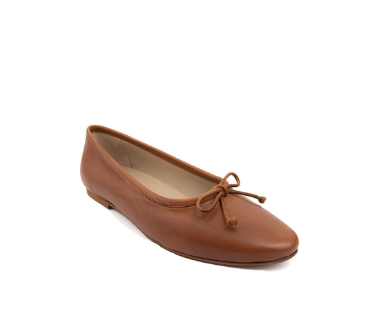 Tan leather ballet flat with a rounded toe and bow detail, shown at an angle.